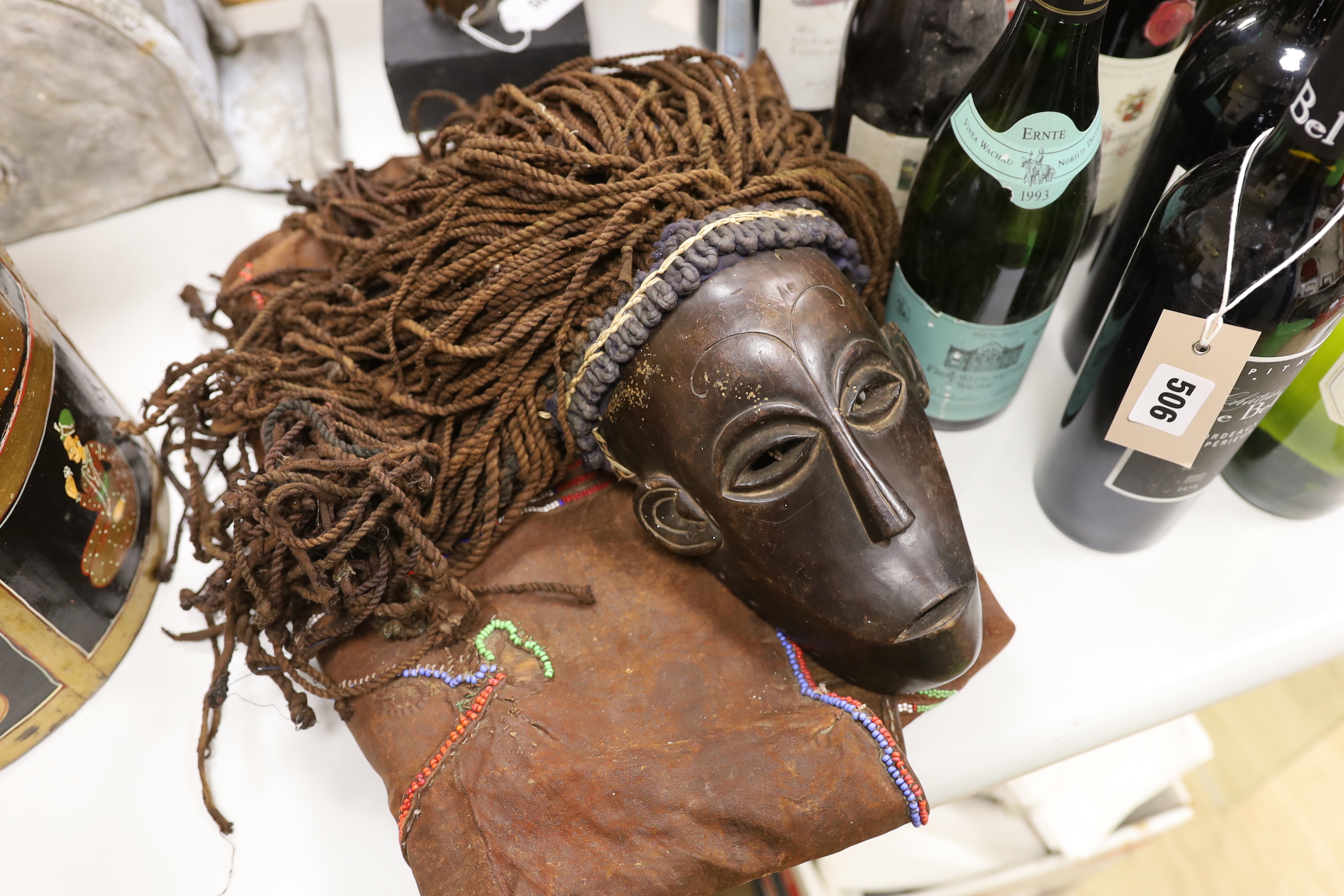 A Massai apron, dan mask and an African carving